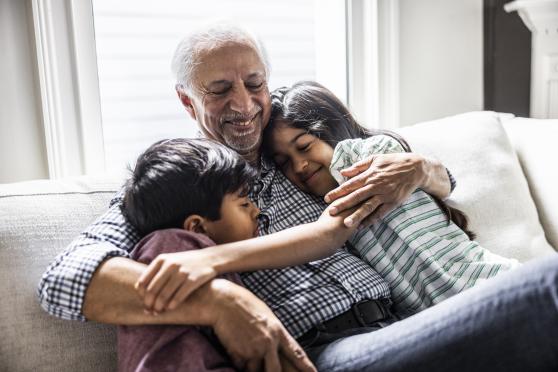 A man hugs his grandchildren